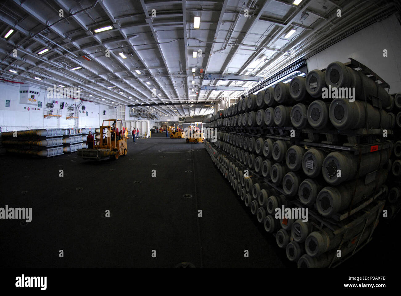 SOUTH CHINA SEA (April 5, 2007) - Aviation ordnanceman fill the hangar bay of Nimitz-class aircraft carrier USS Ronald Reagan (CVN 76) with ammunition and ordnance to prepare for an ammo offload. Ronald Reagan Carrier Strike Group is underway in the South China Sea in support of U.S. military operations. U.S. Navy Stock Photo