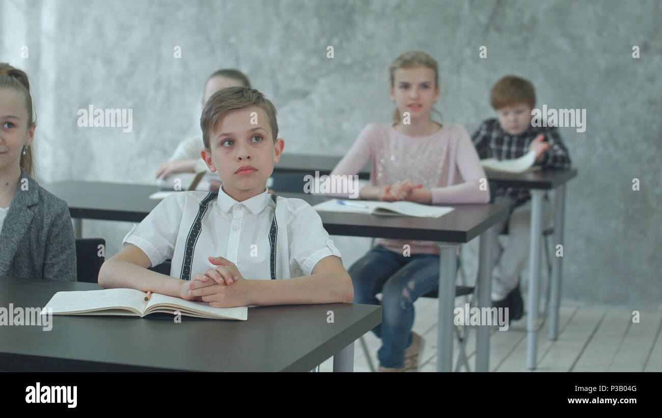Kids applauding teacher in class Stock Photo