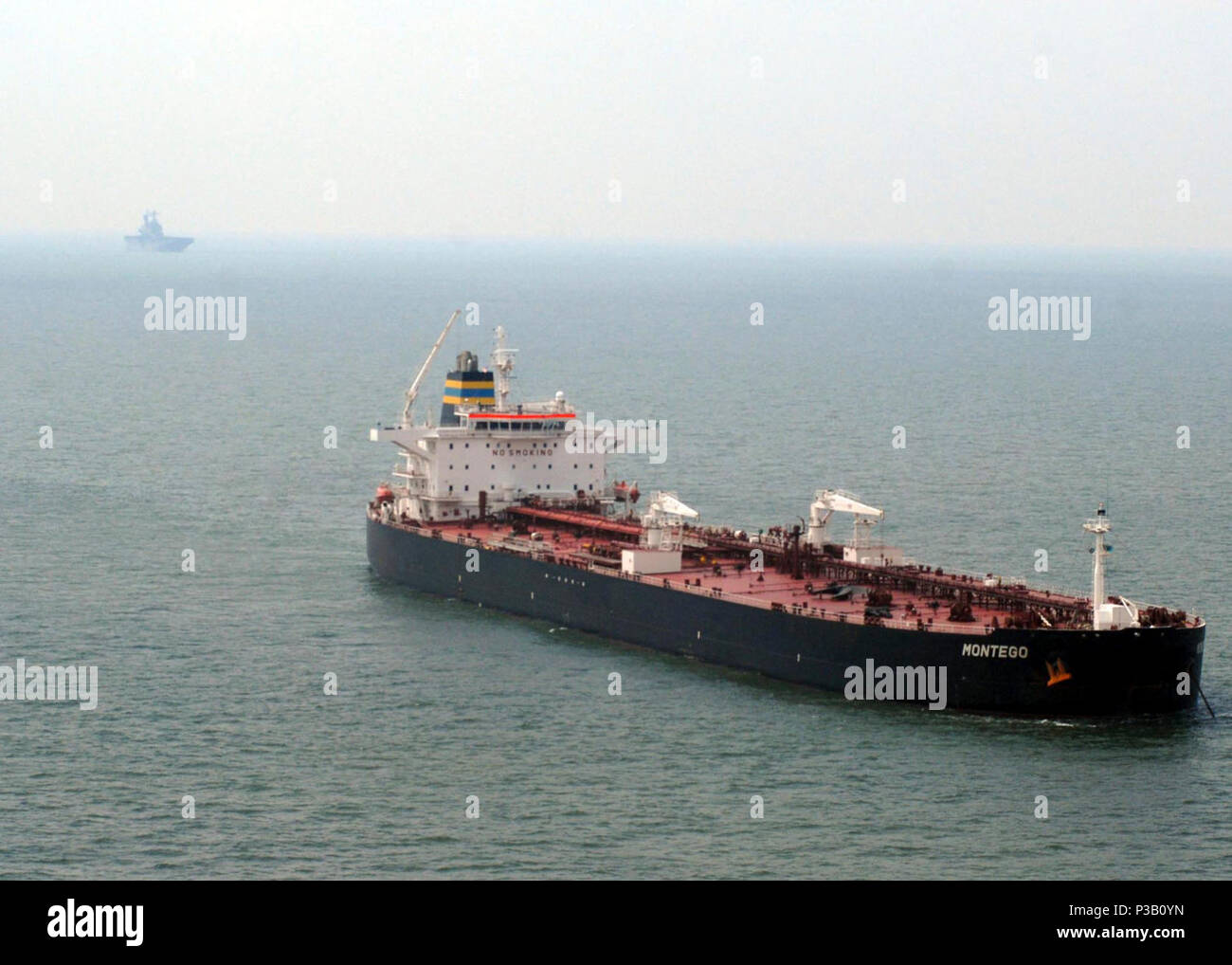 Texas (Sept. 19, 2008) Merchant ships are anchored off the coast of Galveston, waiting for the port to reopen during the recovery following Hurricane Ike devastation. Amphibious Construction Battalion (ACB) 2 Disaster Relief Team, embarked aboard the amphibious assault ship USS Nassau (LHA 4), is taking part in the effort to clear the Port of Galveston. Nassau is anchored off the coast of Galveston to provide defense support to civil authorities as directed in the wake of Hurricane Ike. Stock Photo