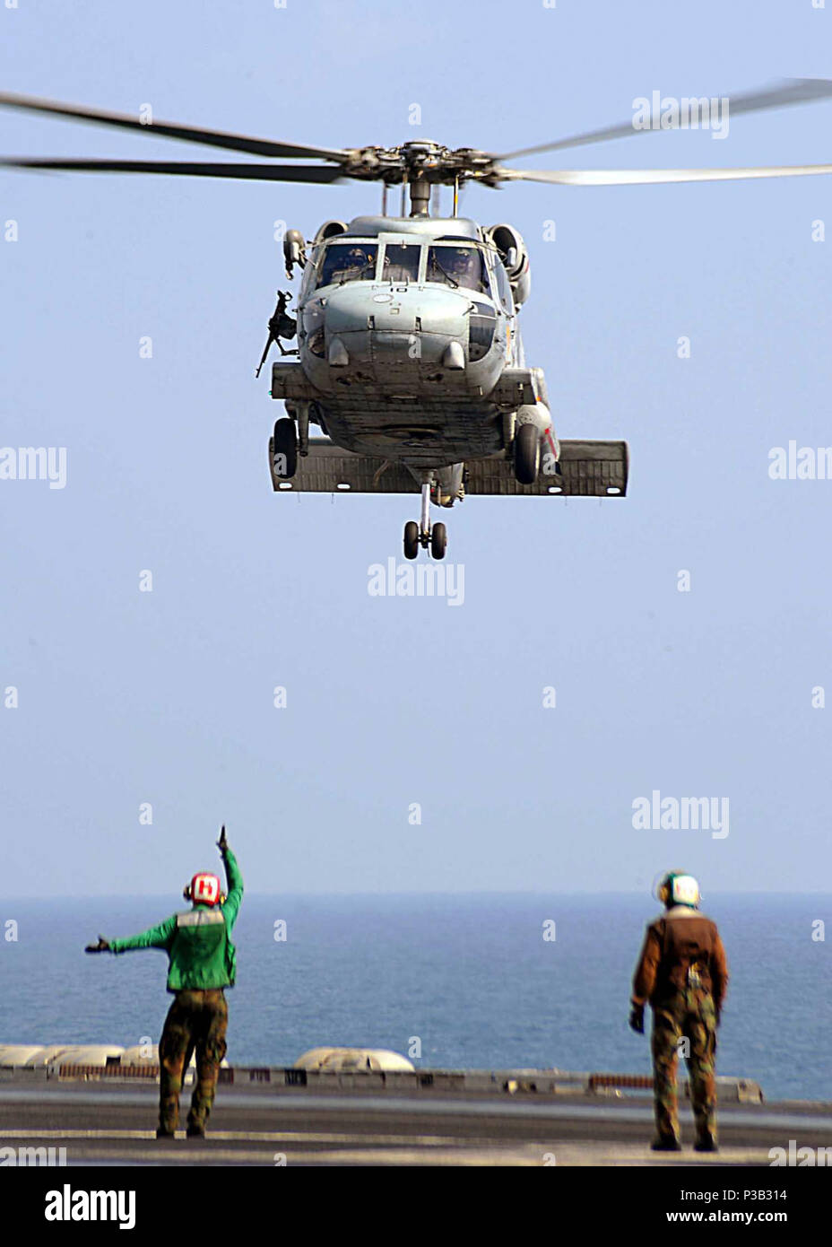 OF OMAN (Dec. 17, 2008) An SH-60F Sea Hawk assigned to the 'Tridents' of Helicopter Anti-Submarine Squadron (HS) 3 prepares to touch down on the flight deck of he Nimitz-class aircraft carrier USS Theodore Roosevelt (CVN 71). Theodore Roosevelt and Carrier Air Wing (CVW) 8 are conducting operations in the U.S. 5th Fleet area of responsibility and are focused on reassuring regional partners of the United States' commitment to security, which promotes stability and global prosperity. Stock Photo