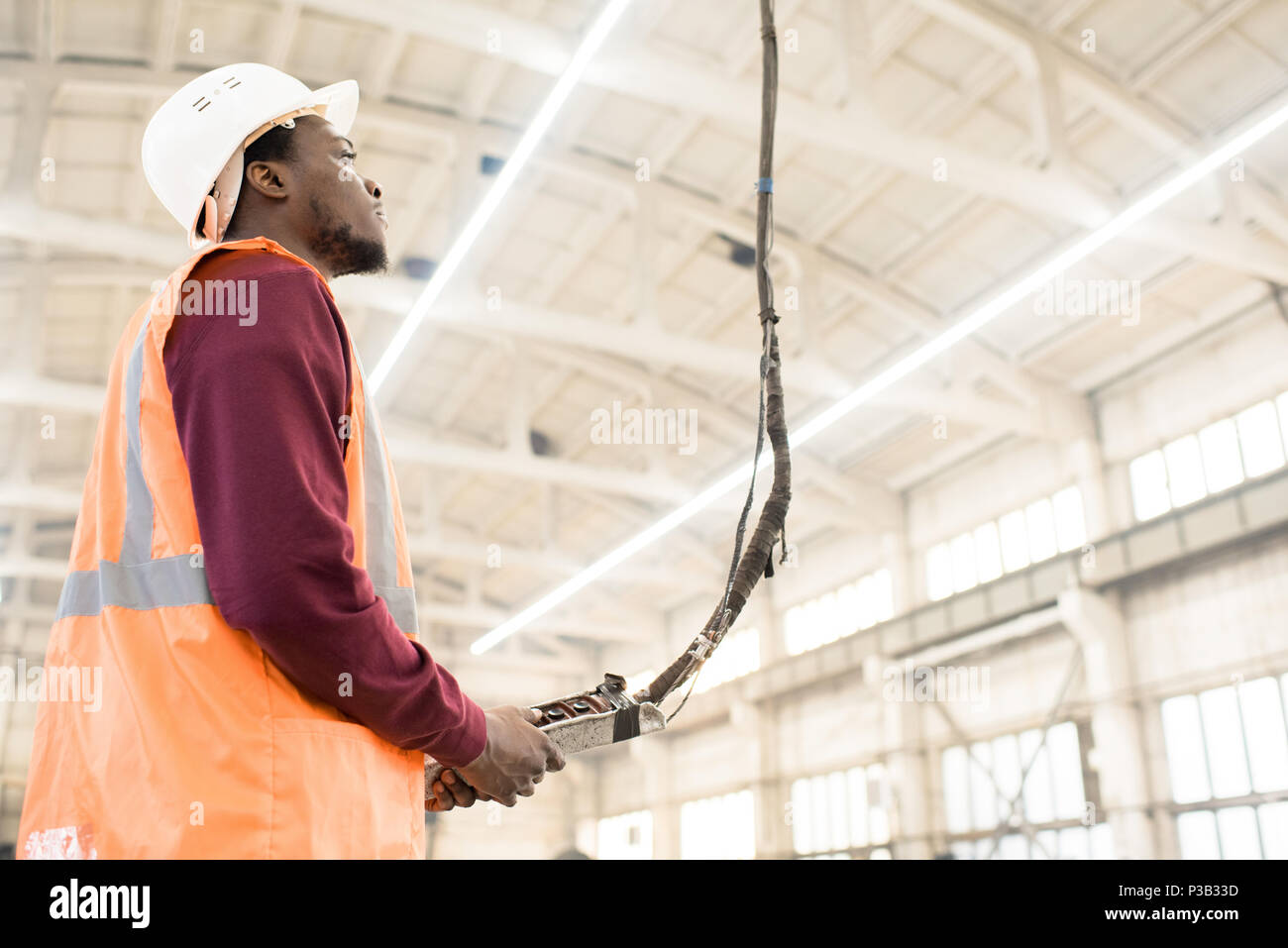 Construction worker using crane controller Stock Photo Alamy
