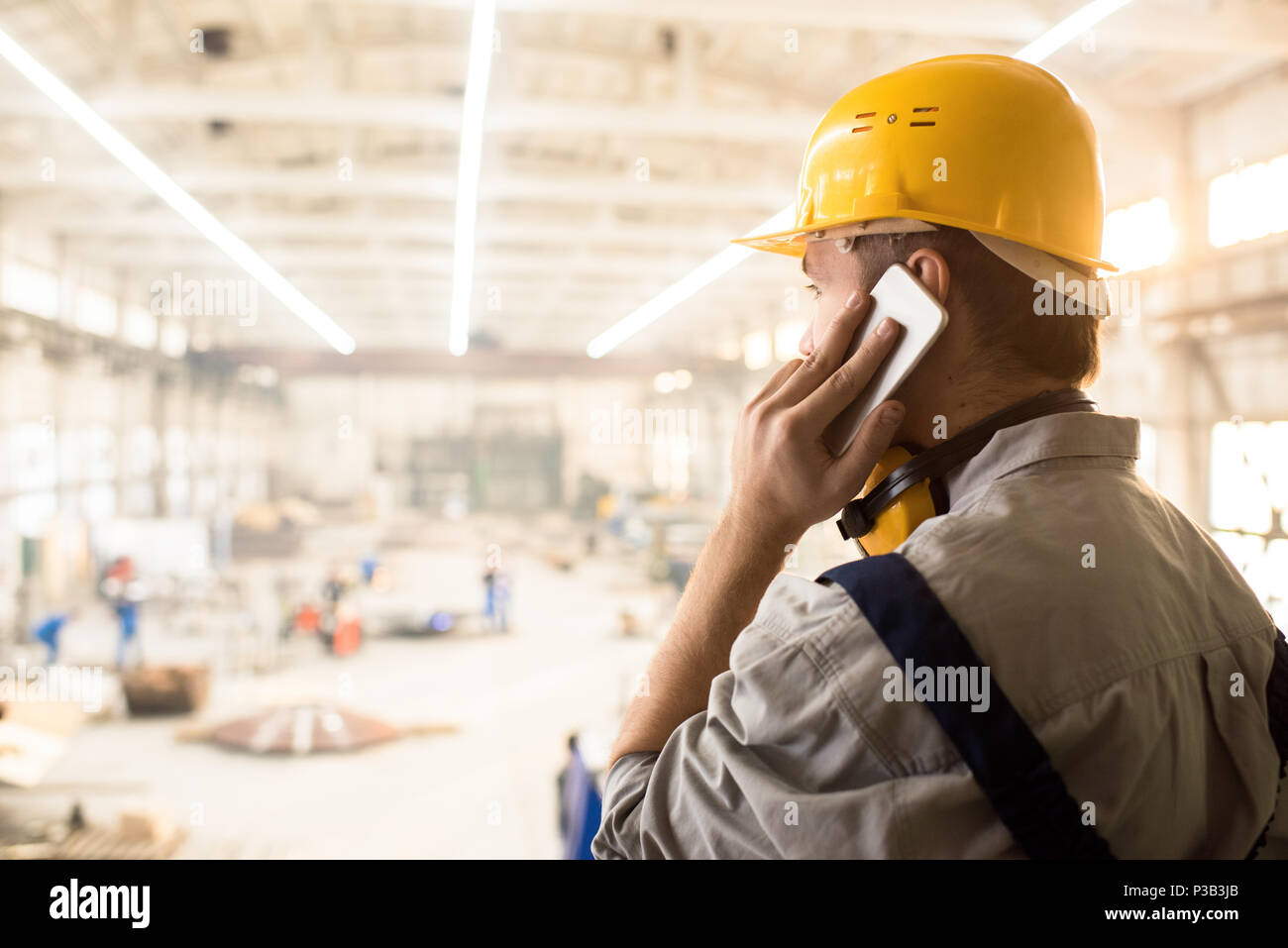 Busy construction manager calling customer Stock Photo