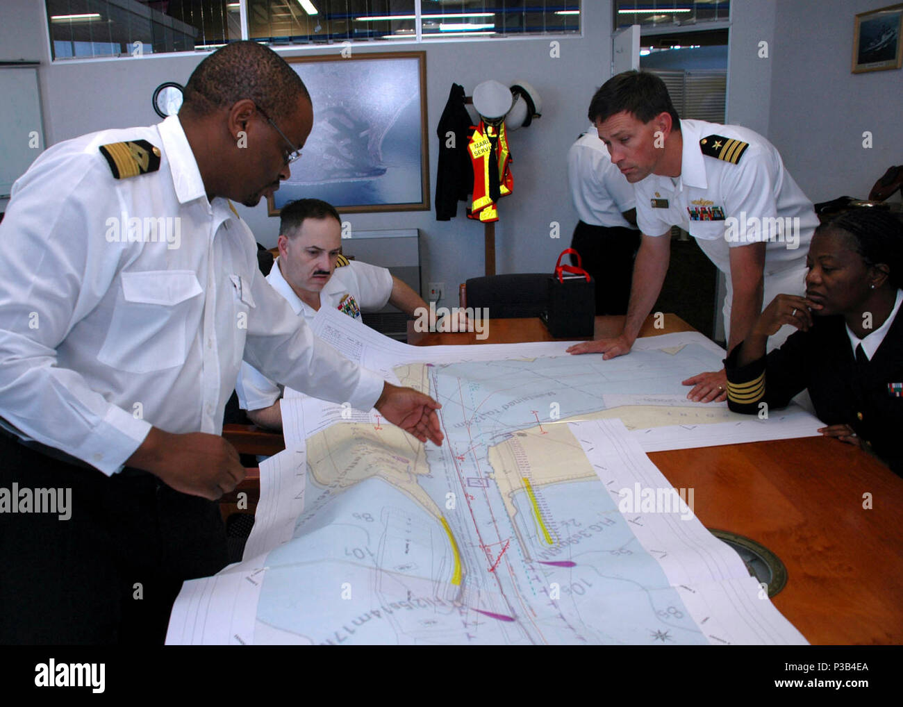 From left, South African Capt. Rufus Lekala, Durban harbor master, discusses the layout of local channels with U.S. Navy Capt. Jim Tranoris, commodore of Commander, Task Force 363, and U.S. Navy Cmdr. Bob Moum, commanding officer of USS Arleigh Burke (DDG 51) in Durban, South Africa, July 13, 2009. Arleigh Burke is in Durban to start a series of cooperative evolutions with the South African navy as part of a scheduled military-to-military engagement. (DoD Stock Photo