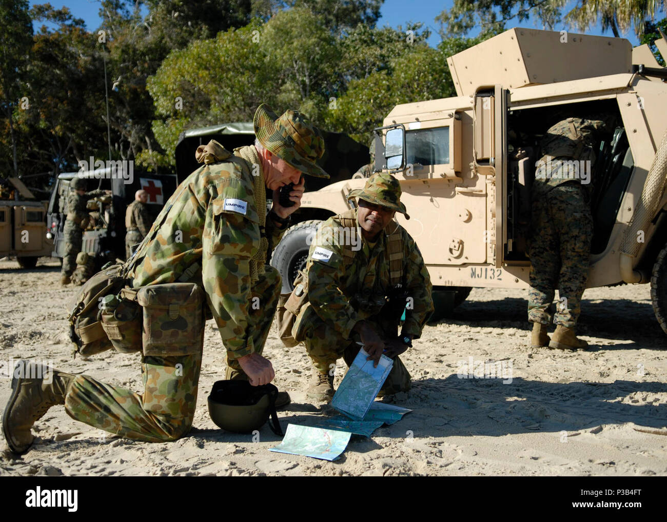 From left, Australian Defense Force Maj. Brian D' Cunha and Lt. Col. Merv  Wren look at maps and establish communications during Talisman Sabre 2009  on Freshwater Bay Beach in Queensland, Australia, July