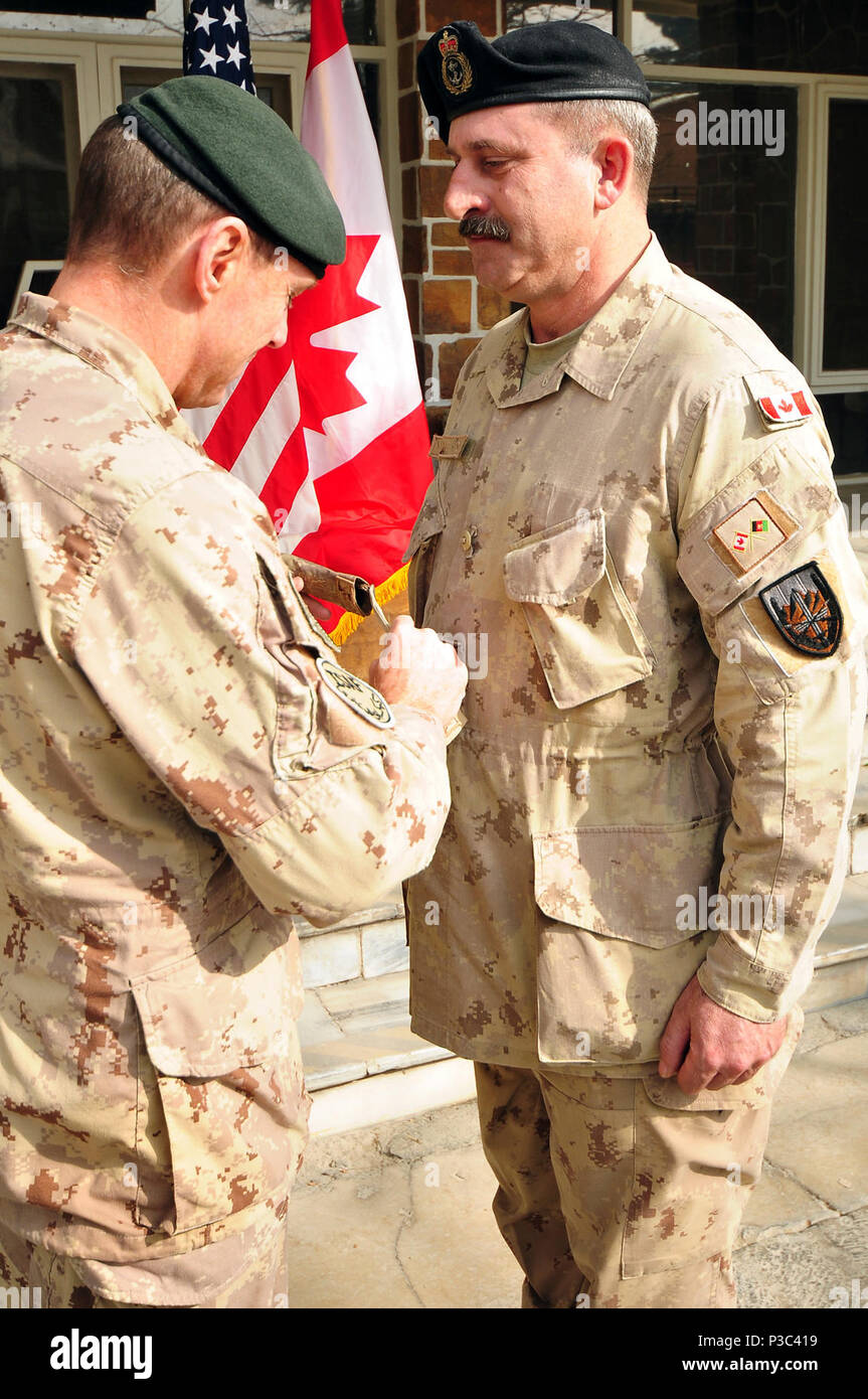 Kabul, Afghanistan (November 30, 2009)- Canadian Maj. Gen. Mike Ward, left, Deputy Commander NATO Training Mission-Afghanistan (NTM-A), from Ottawa, Ontario, presents Canadian, Chief Petty Officer 2nd Class Trevor Spring,  from Pleasantville, Nova Scotia, with the rank of  Chief Petty Officer 1st  Class, the highest enlisted rank in the Canadian Navy. “This is the culmination of my career,” said Spring. The promotion was held at Camp Eggers, the headquarters for the newly established command, NATO Training Mission-Afghanistan, on Nov. 30, 2009. Stock Photo