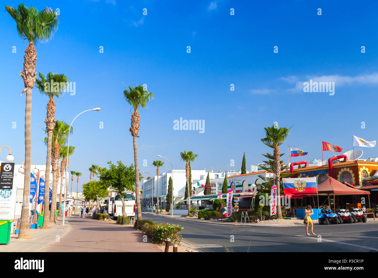 Ayia Napa, Cyprus - June 11, 2018: Agia Napa town on south coast of Cyprus island, street view at summer day. Tourists walk on street Stock Photo