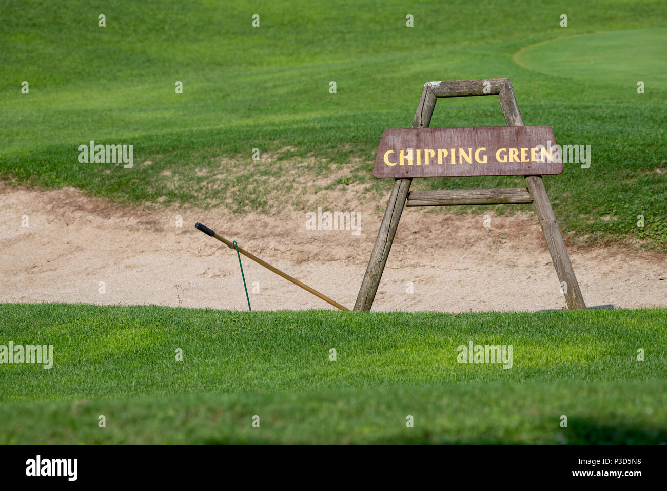 Chipping green sign in front of bunker on golf course Stock Photo Alamy