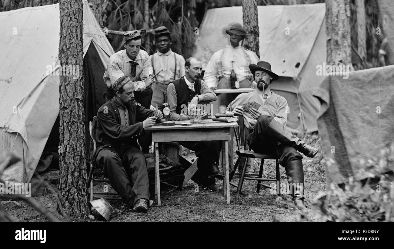 . English: Officers of the 114th Pennsylvania Infantry drinking alcohol and playing cards in front of tents . August 1864 3 Officers-of-the-114th-pennsylvania-03882a-crop Stock Photo