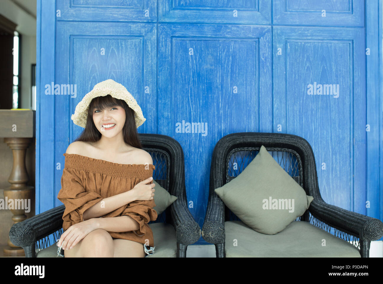 Young beautiful girl happy and relaxing on the armchair, Hua Hin, Thailand Stock Photo