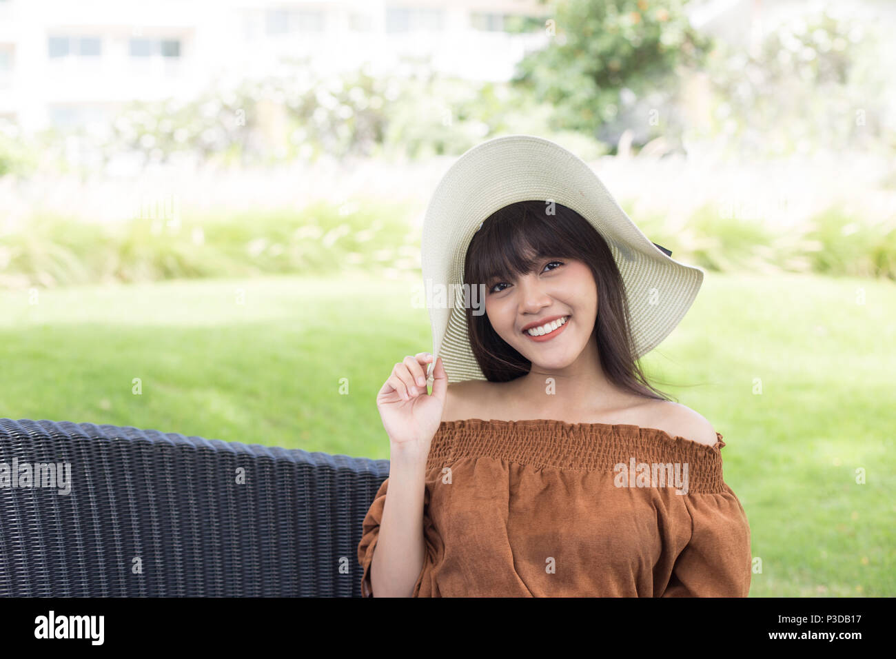 Young beautiful girl happy and relaxing on the armchair, Hua Hin, Thailand Stock Photo