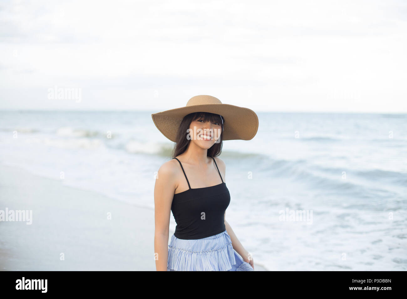 Young girl enjoy and happy her relaxing on the beach, Hua Hin, Thailand Stock Photo