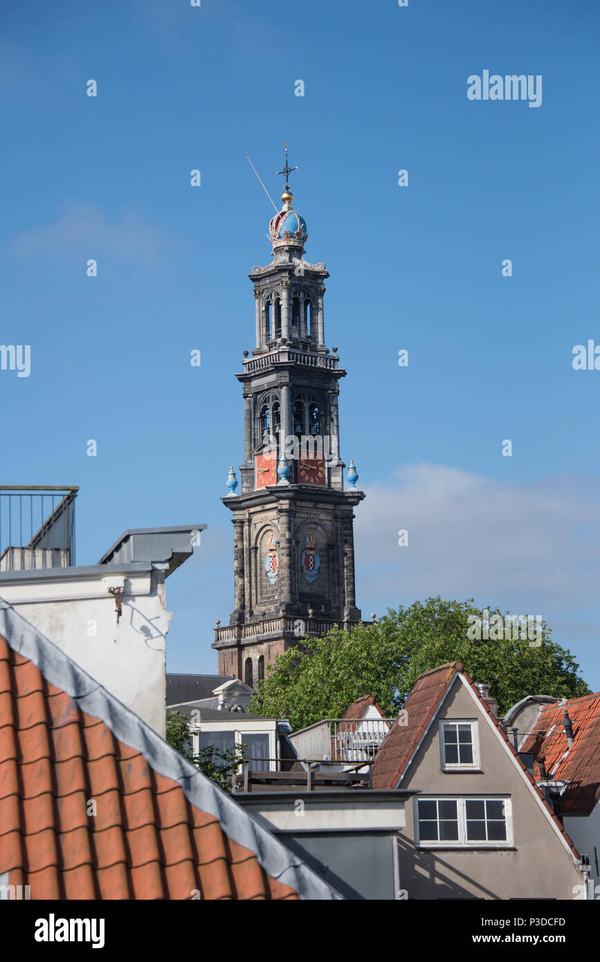The spire of the church where Rembrandt is supposed to be buried seen over the rooftops in the canal district of Amsterdam Stock Photo
