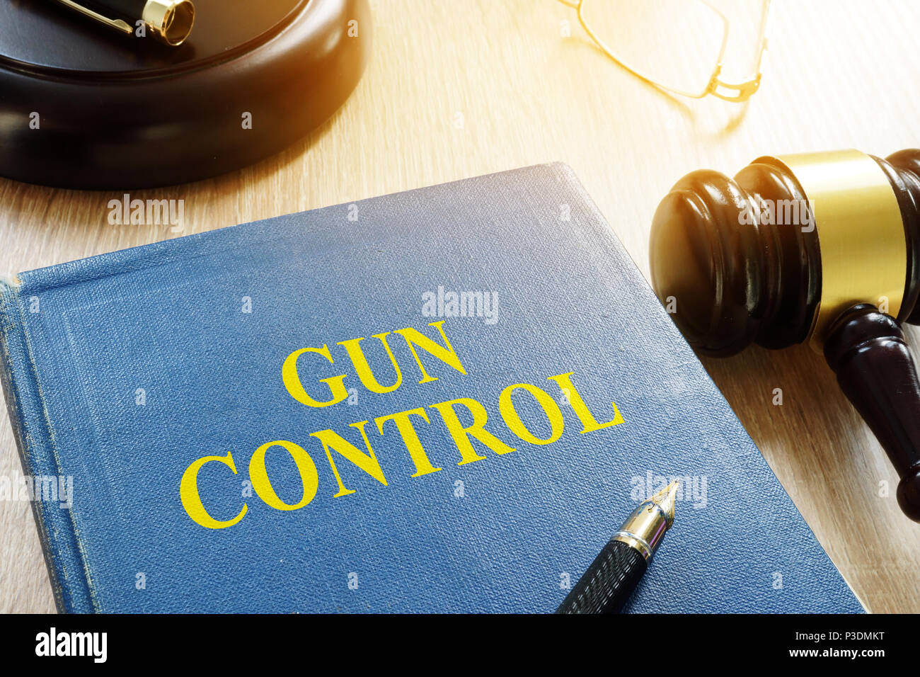 Gun control law and gavel on a table. Stock Photo