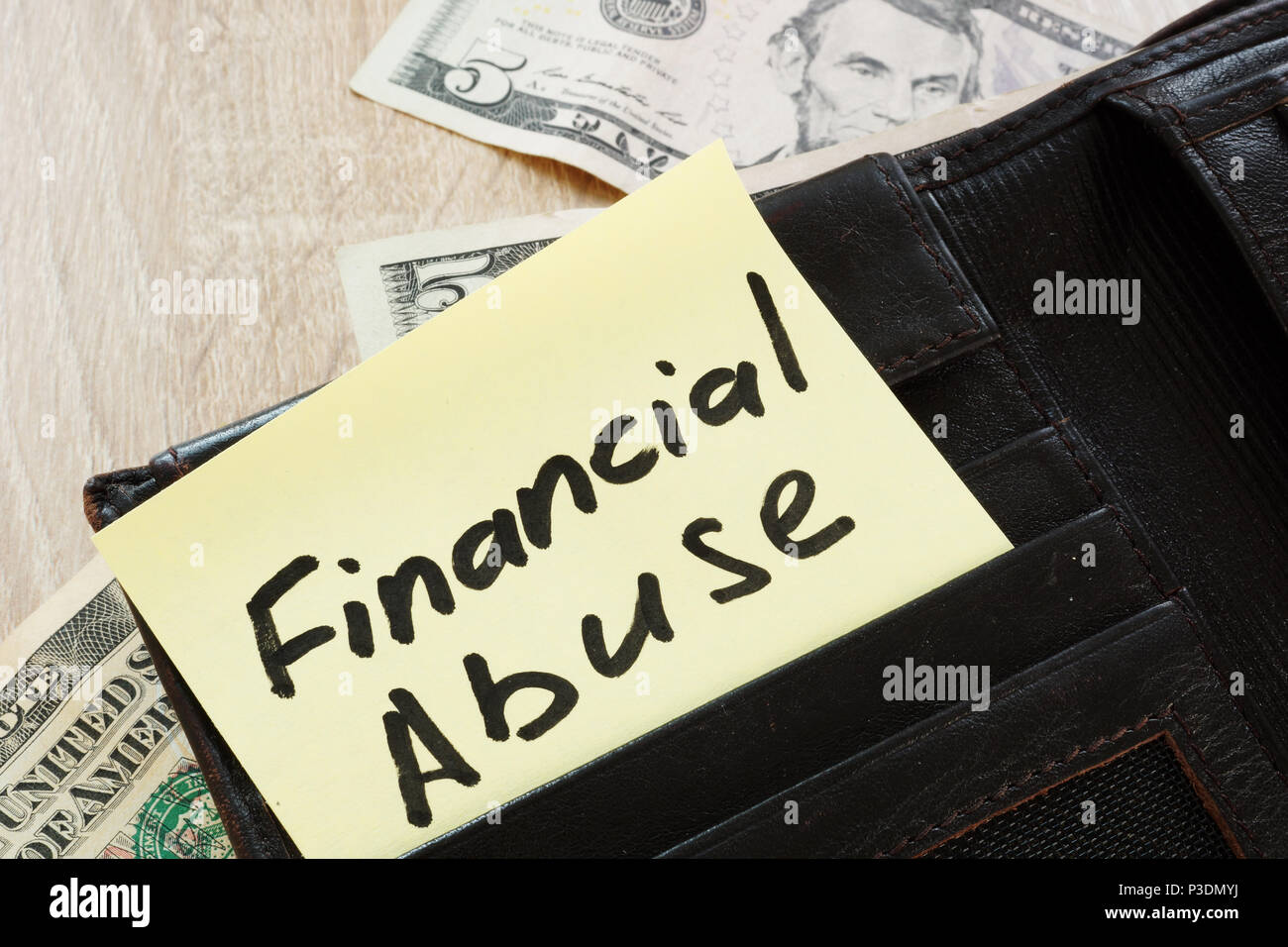 Open wallet with words Financial abuse. Stock Photo