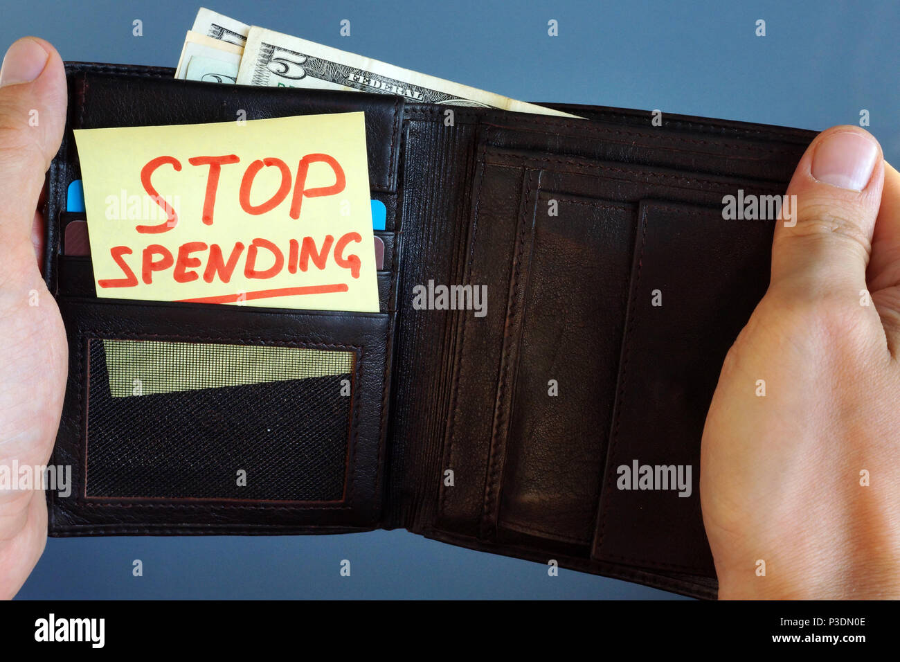 Hands holding wallet with stick Stop spending. Stock Photo