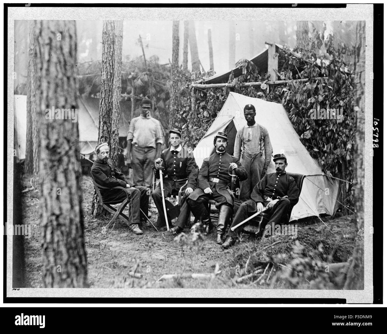 . Officers of 114th Pennsylvania Infantry in front of Petersburg, Va., August, 1864. Four union officers in front of tent, with two Afro-American Servants(?). 1864 3 Officers of the 114th pennsylvania 3c05798u Stock Photo