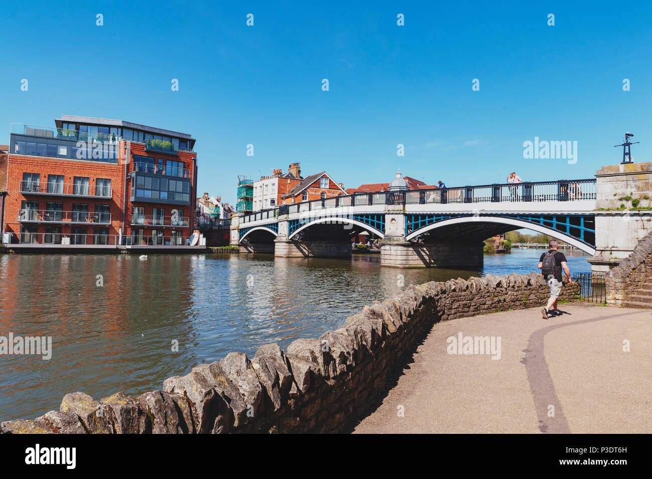 The River Thames flowing through Windsor and Eton, twin towns, in Berkshire, in the South East of England, joined by Windsor Bridge, Berkshire, UK Stock Photo