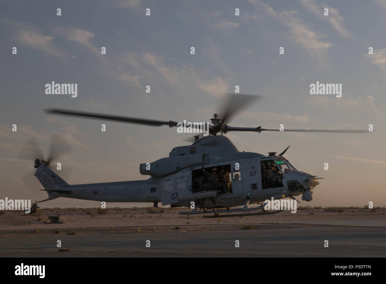 Marines with Marine Light Attack Helicopter Squadron 775, Marine Aircraft Group-41, 4th Marine Aircraft Wing, take off in a UH-1Y Venom for night operations during Integrated Training Exercise 4-18 at Marine Corps Air Ground Combat Center Twentynine Palms, California, June 12, 2018. HMLA-775, also known as the “Coyotes”, provides air combat element support to Marine Air Ground Task Force 23 during ITX 4-18.  (U.S. Marine Corps photo by Lance Cpl. Samantha Schwoch/released) Stock Photo
