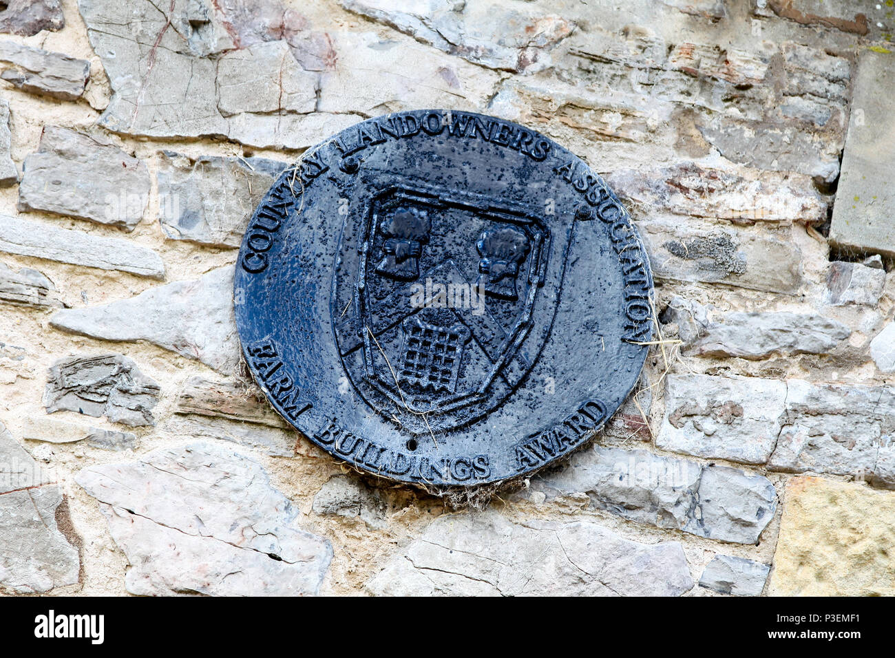 A Country Landowners Association Farm Buildings Award plaque on a stone farm building, Staffordshire, England, UK Stock Photo
