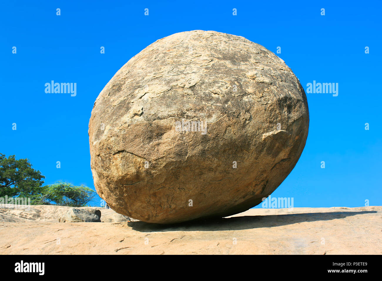 Conceptual image of a balancing butter ball rock in Mahabalipuram,Tamil Nadu,  India Stock Photo