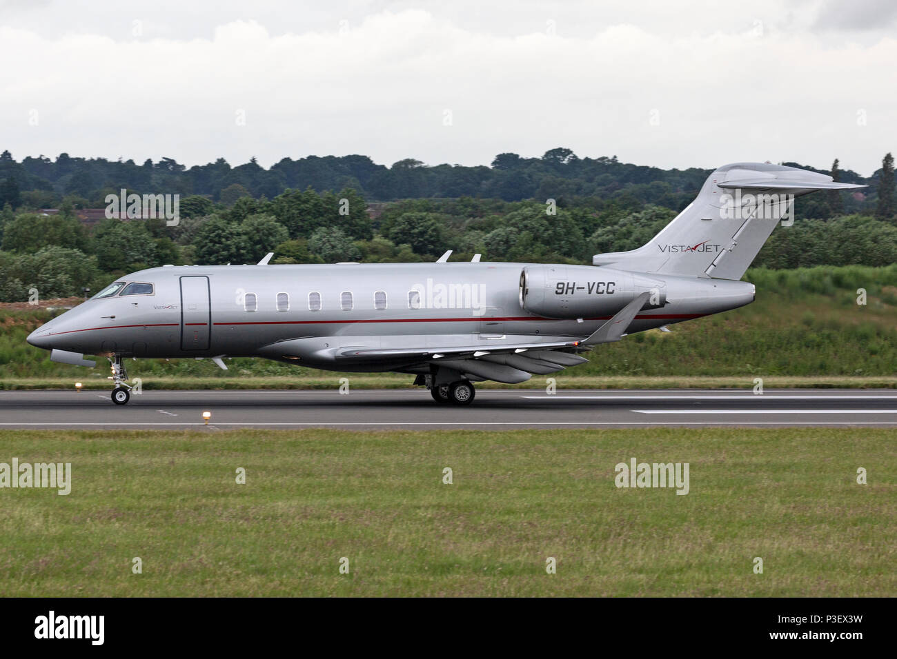 A Bombardier Challenger 300 business corporate jet aircraft, registered in Malta as 9H-VCC, taking off from London Luton airport. Stock Photo