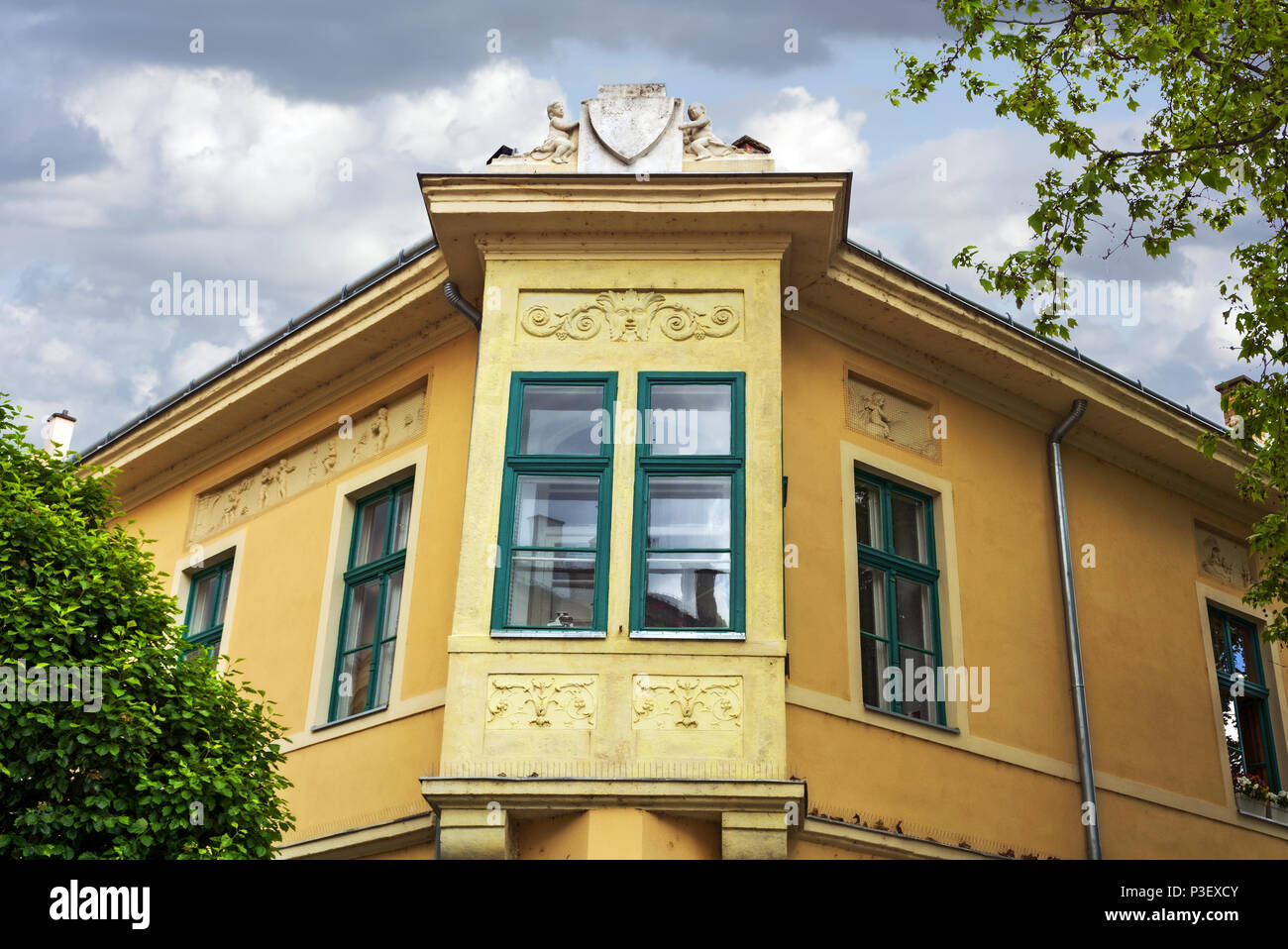 Windowed balcony of a typical old corner house in Székesfehérvár,Hungary.Szekesfehervar was the capital of Hungary in the Middle Ages. Stock Photo