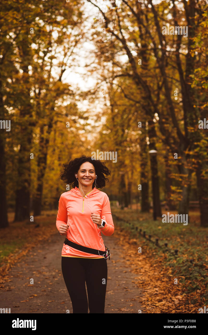 Woman jogging in forest Stock Photo