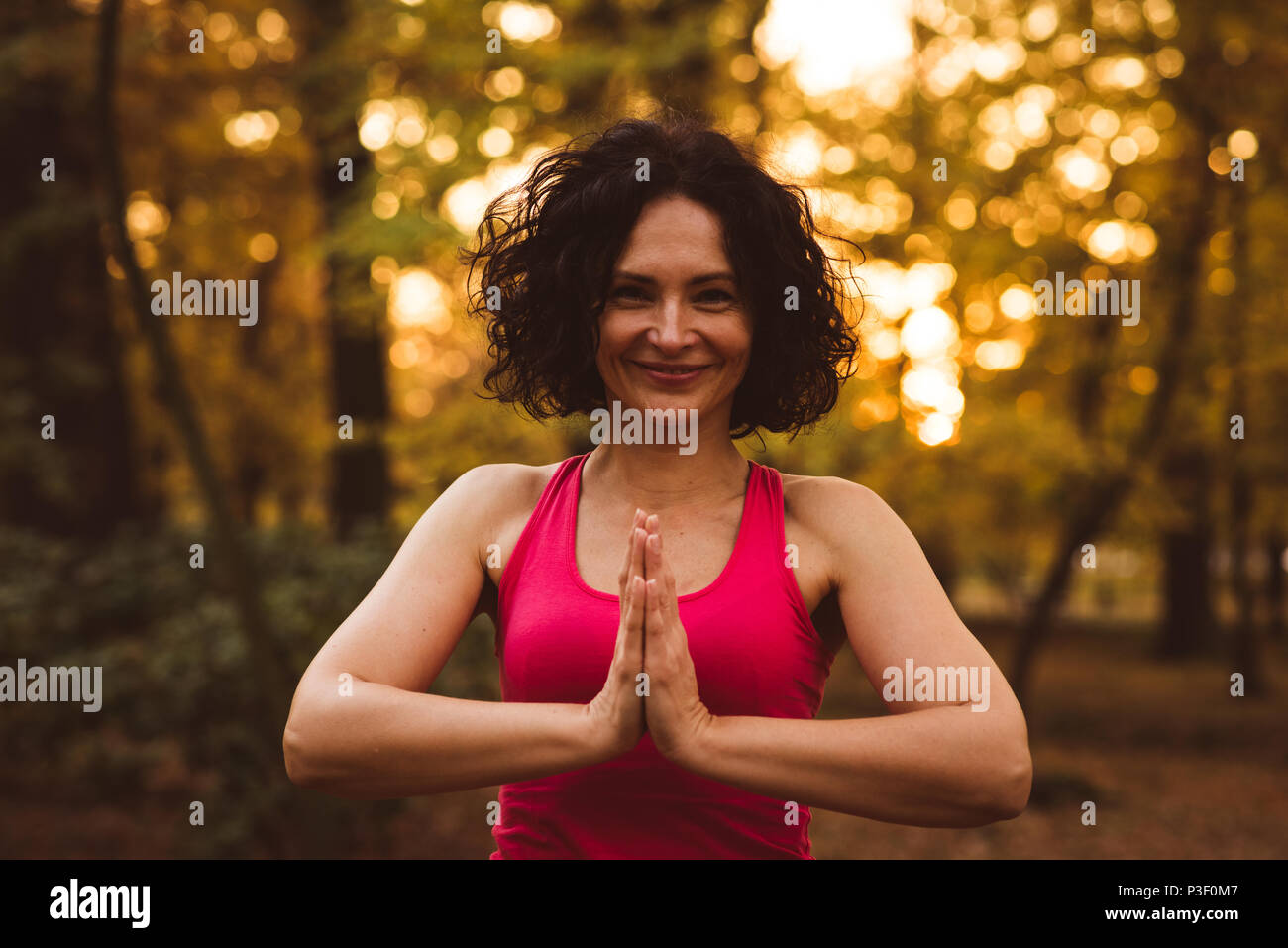 Women meditating in a forest Stock Photo