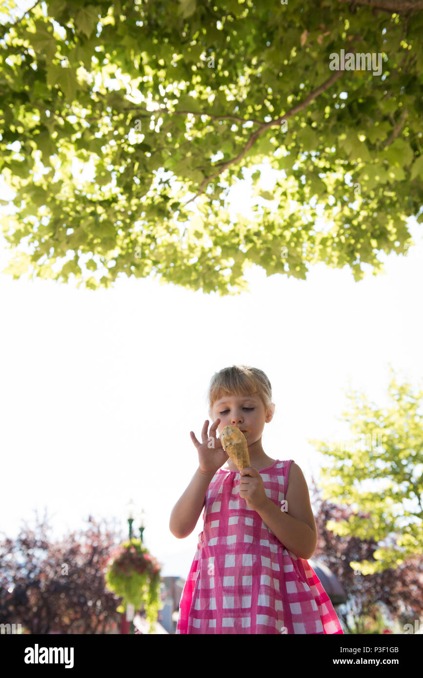 Girl having ice cream on a sunny day Stock Photo