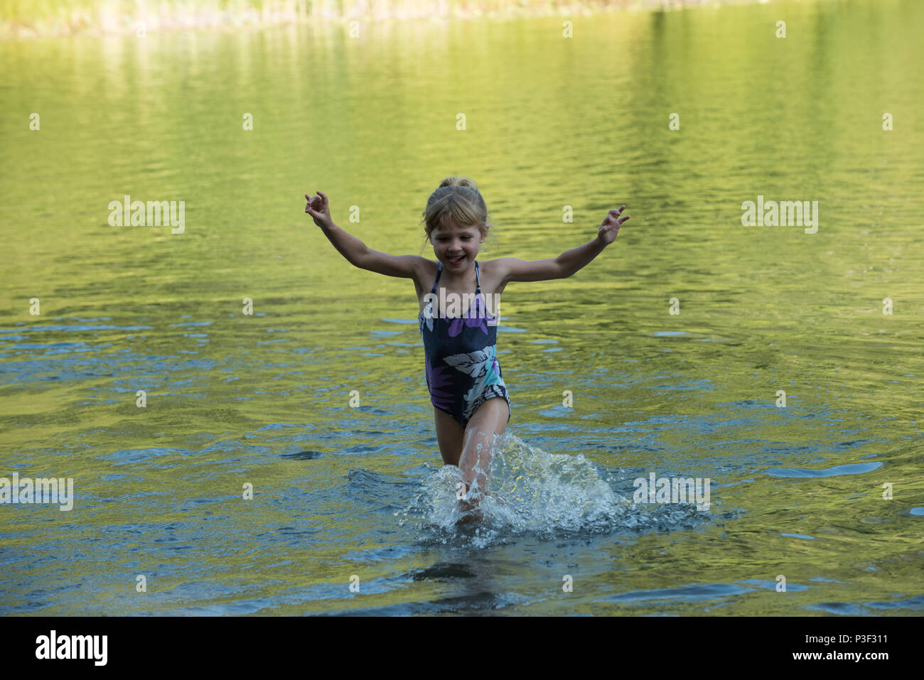 Girl playing in river Stock Photo