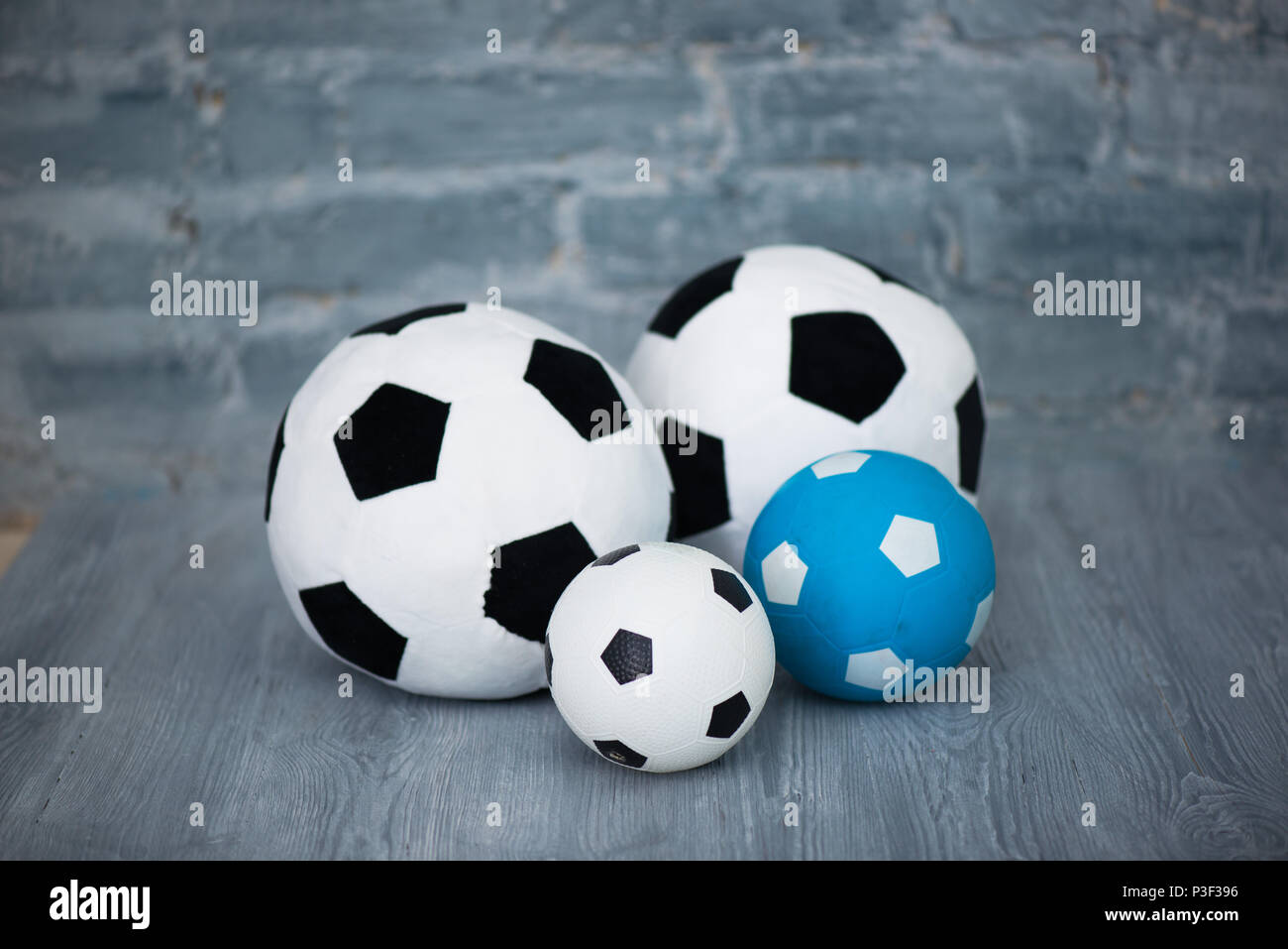 Four soccer balls on a gray brick wall background Stock Photo Alamy