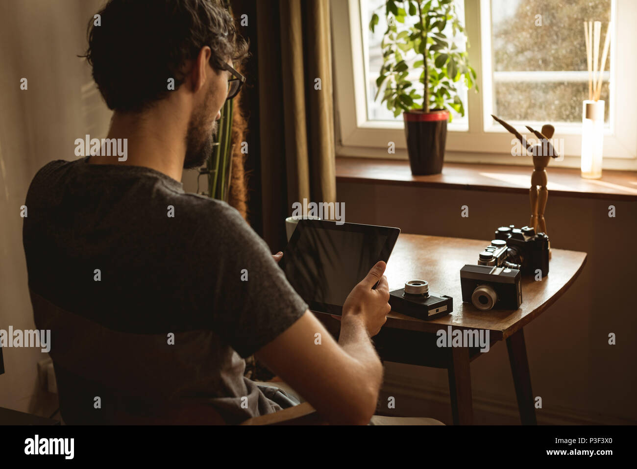 Man using digital tablet in living room Stock Photo