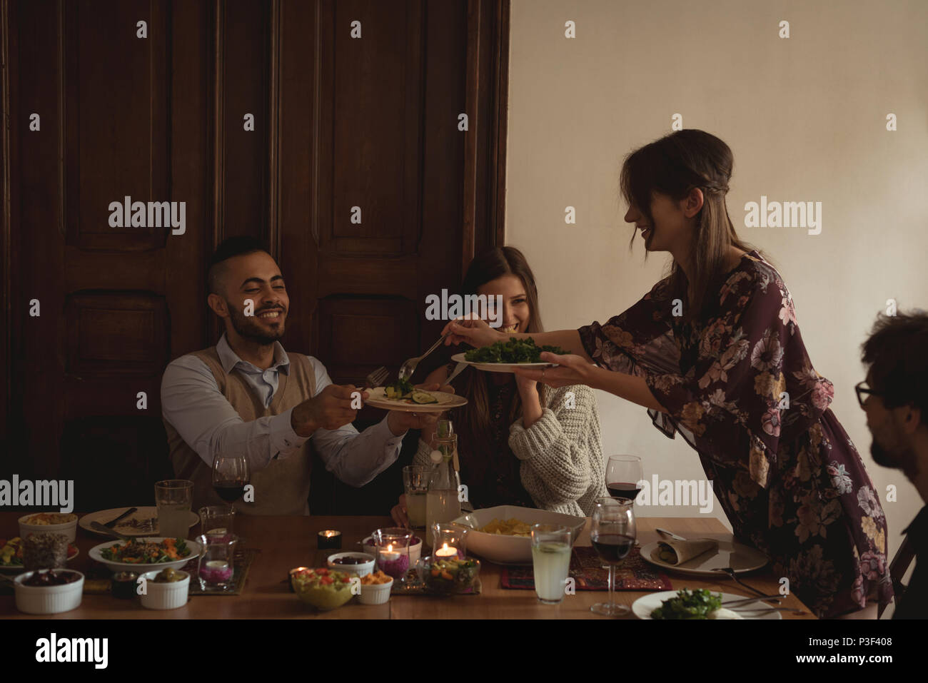 Friends having meal at table Stock Photo
