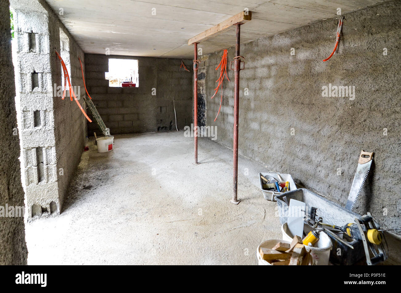 Plastering, rebuilding, waterproofing basement or a cellar and work tools.  Construction of residential house cellar or basement with electric installa  Stock Photo - Alamy