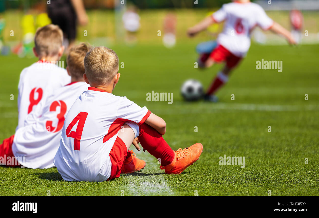 Young Boys Playing Football Match on a Pitch. School Football Tournament for Youth Teams. Football Substitute Players Stock Photo