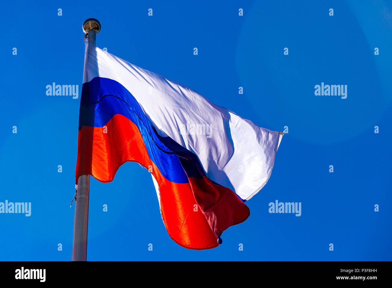 Russian flag against blue sky Stock Photo