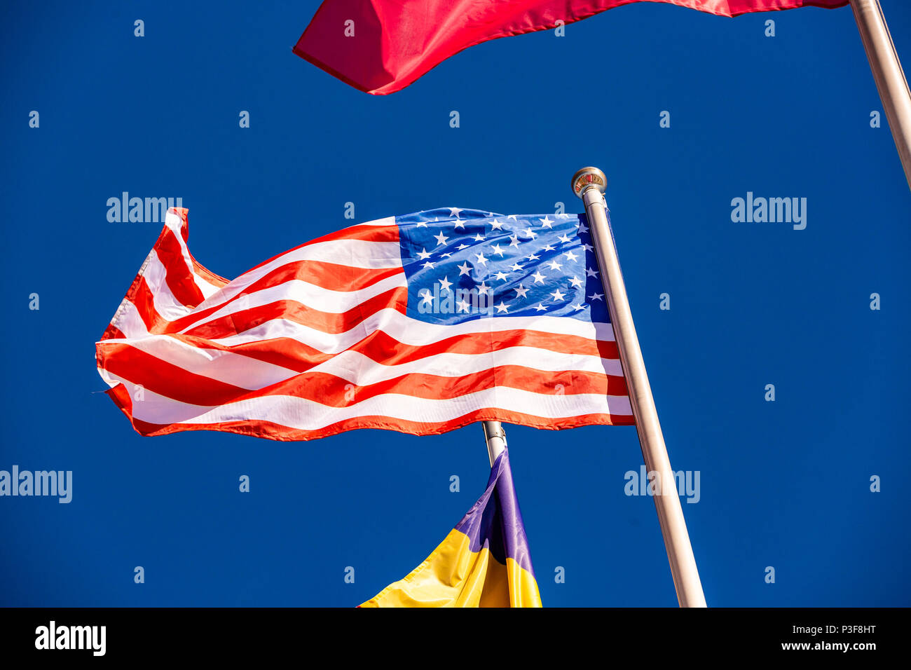 American Flag against blue sky Stock Photo - Alamy