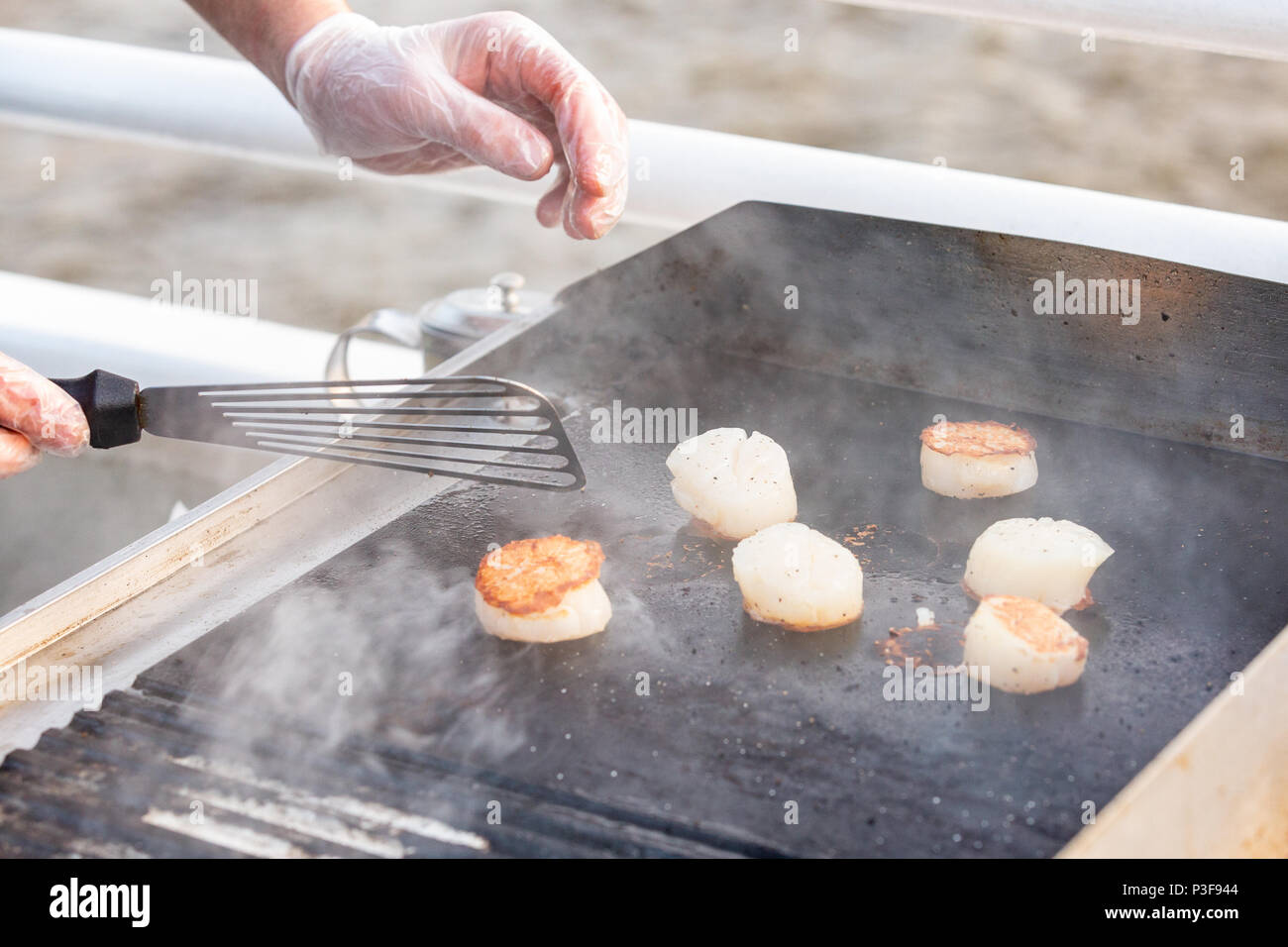 professional chef cooking fish on a barbeque. Portionally fried pieces