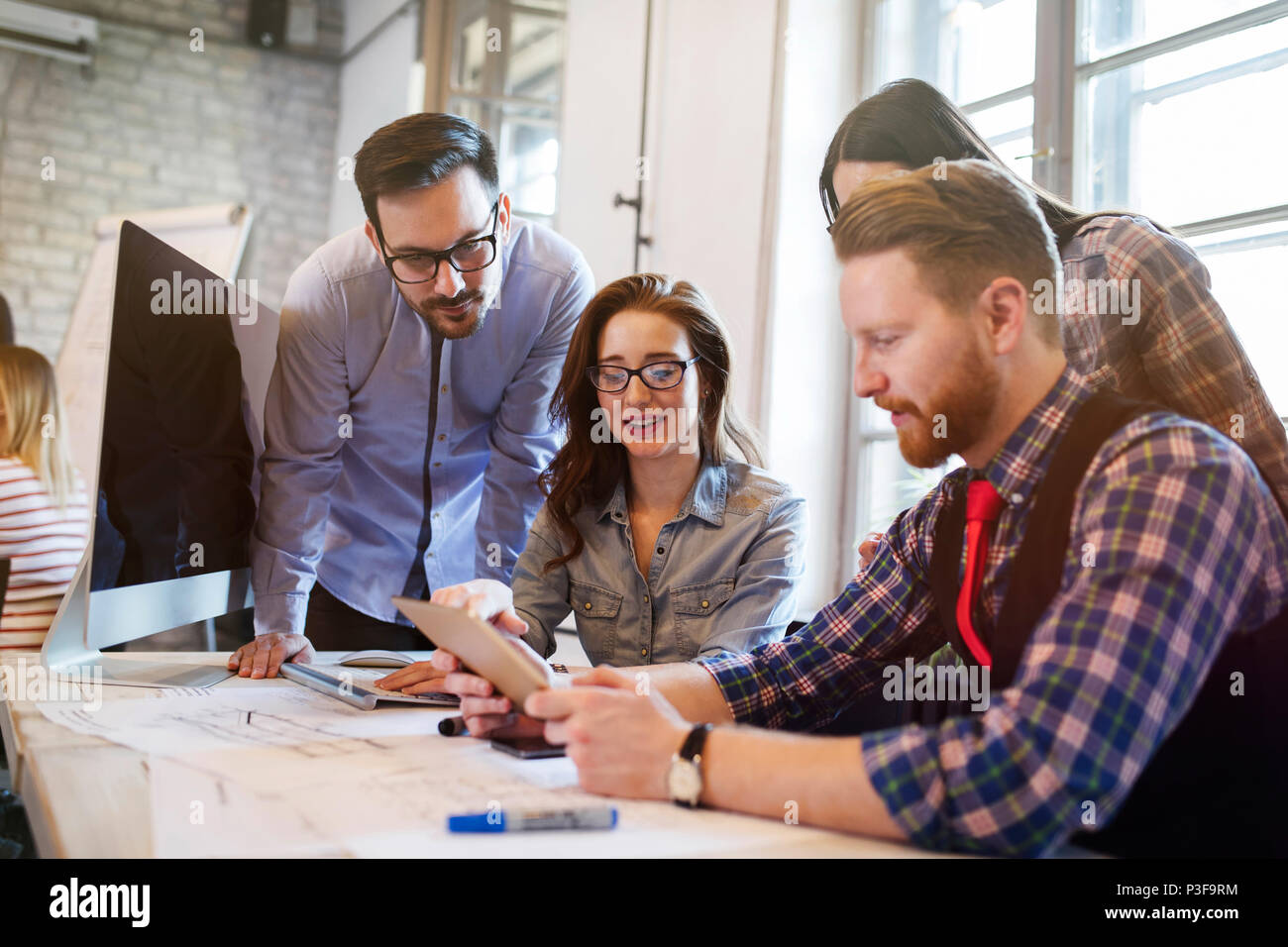 Group of young architects using digital tablet Stock Photo