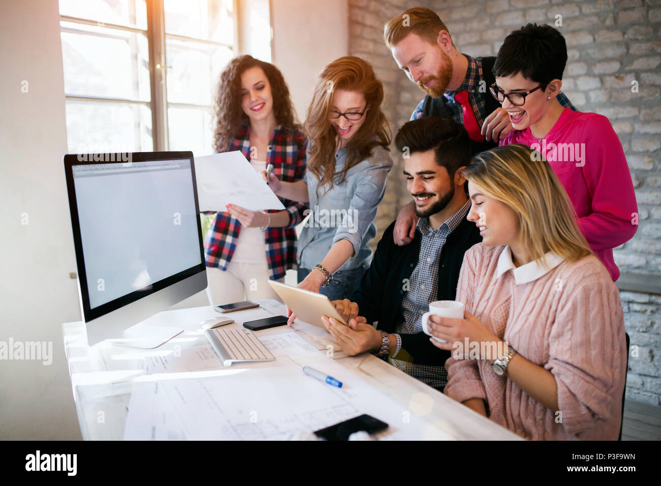 Group of young architects using digital tablet Stock Photo
