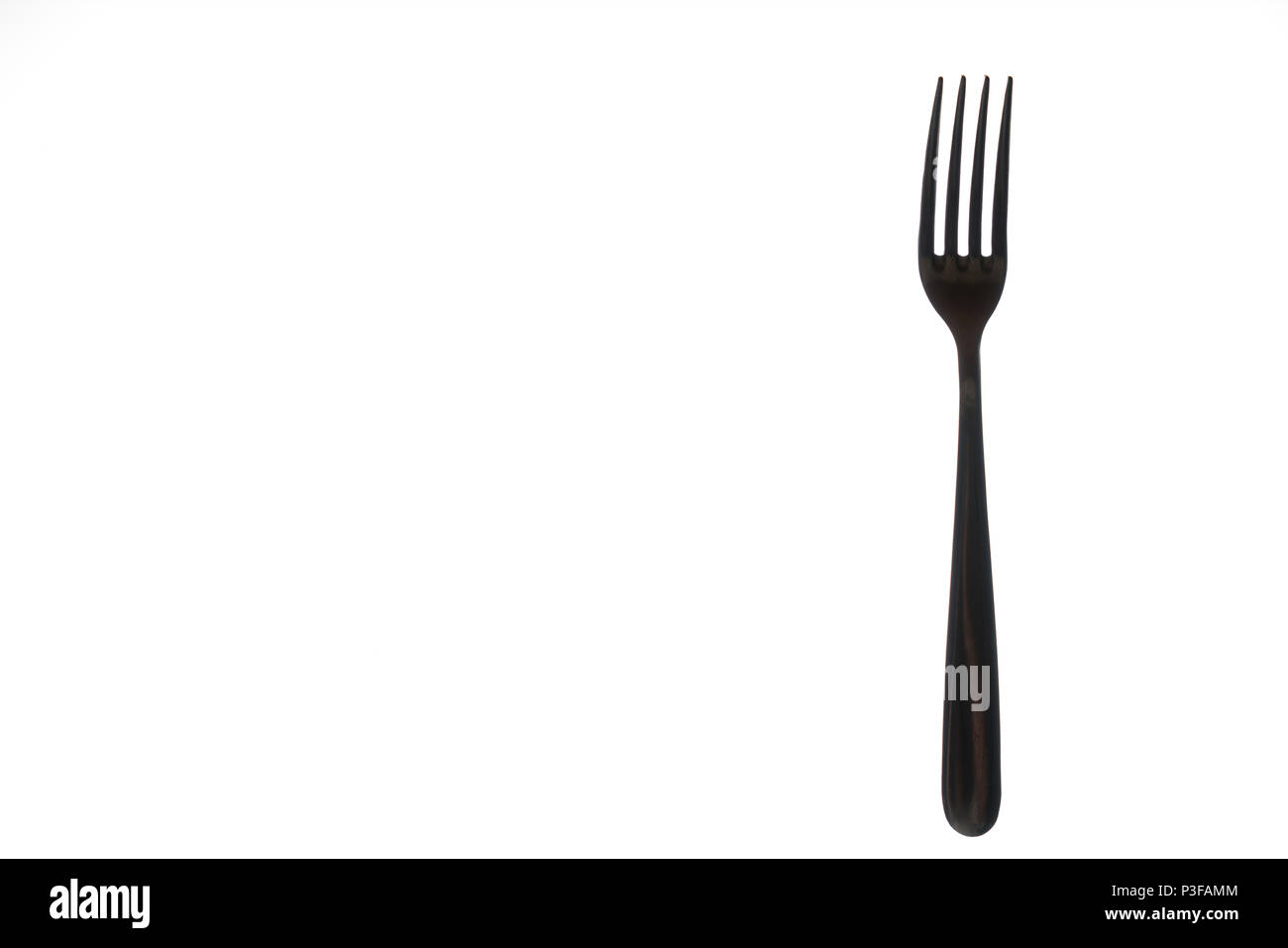 a backlit fork on a white background Stock Photo