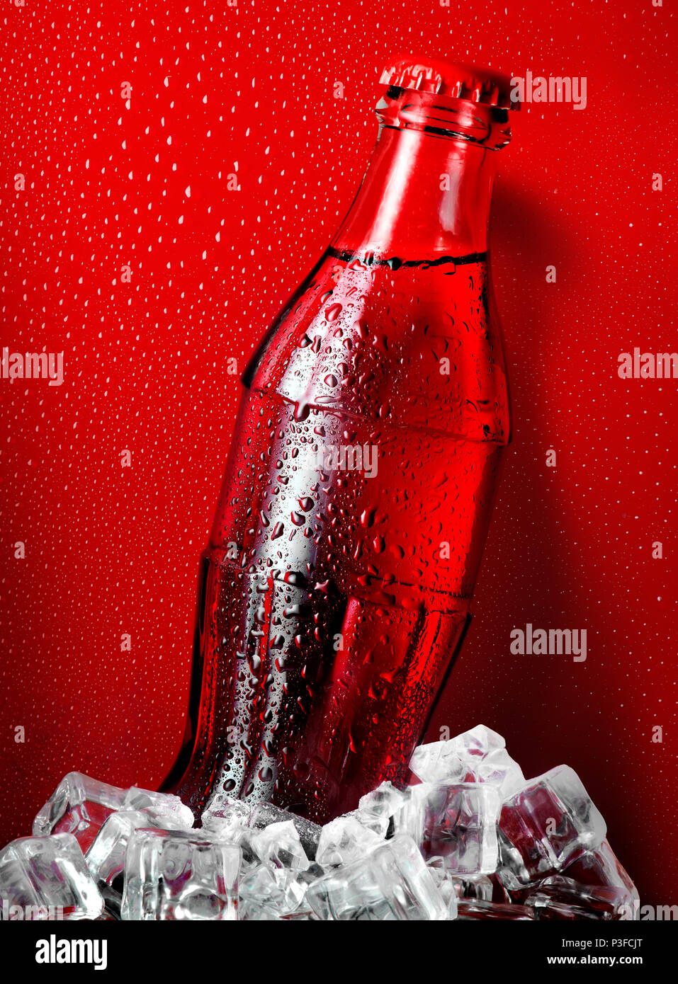 Cola in ice on a red background Stock Photo
