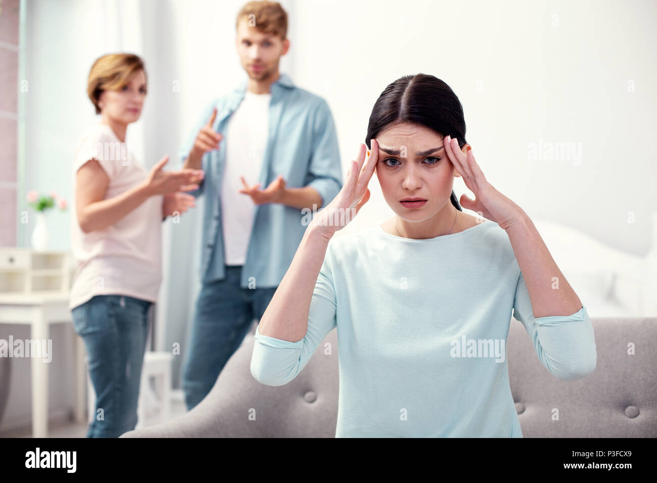Unhappy depressed woman touching her temples Stock Photo