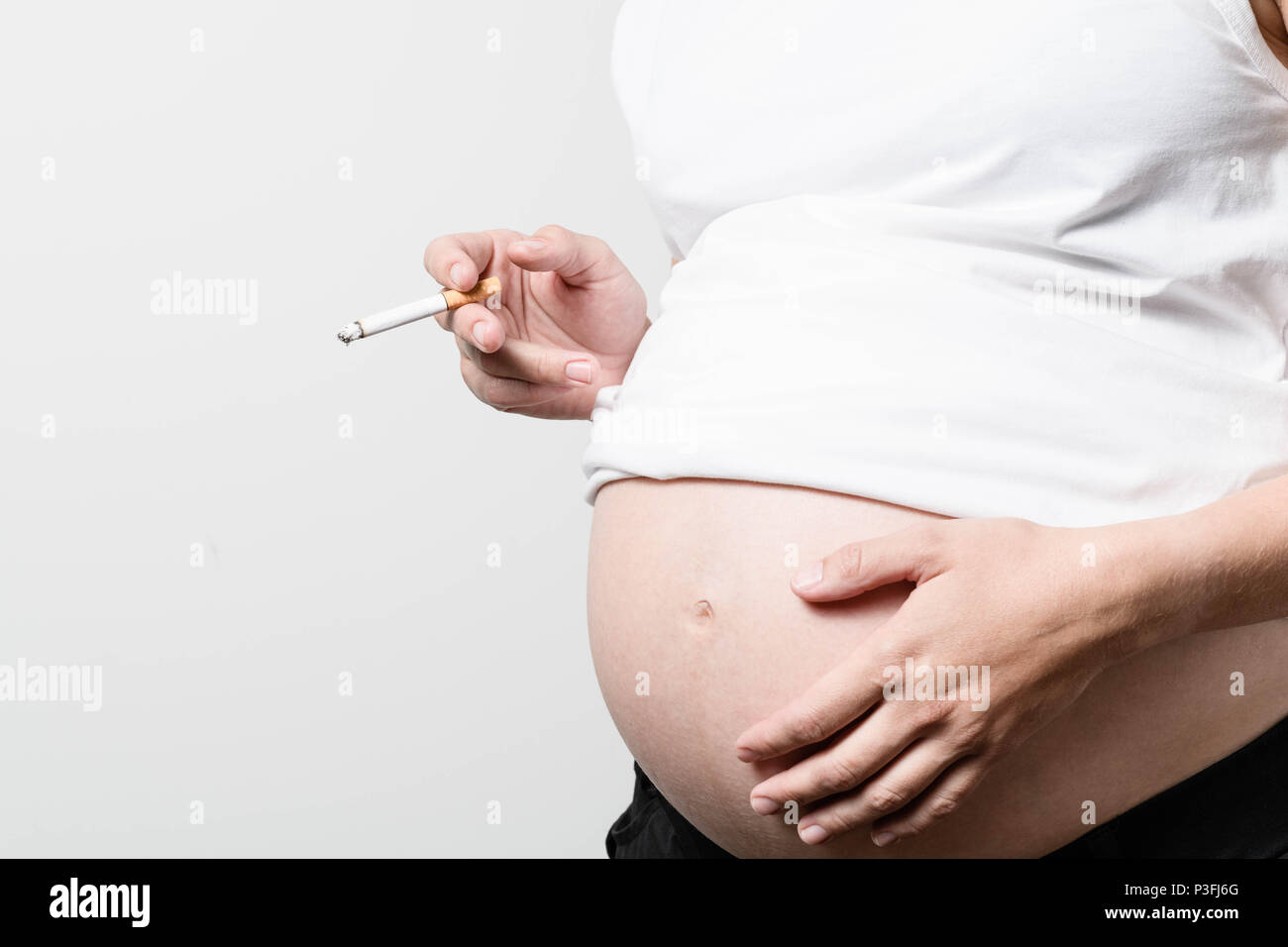Pregnant woman breaks cigarette in half, says no to smoking Stock Photo by  ©SIphotography 51627555