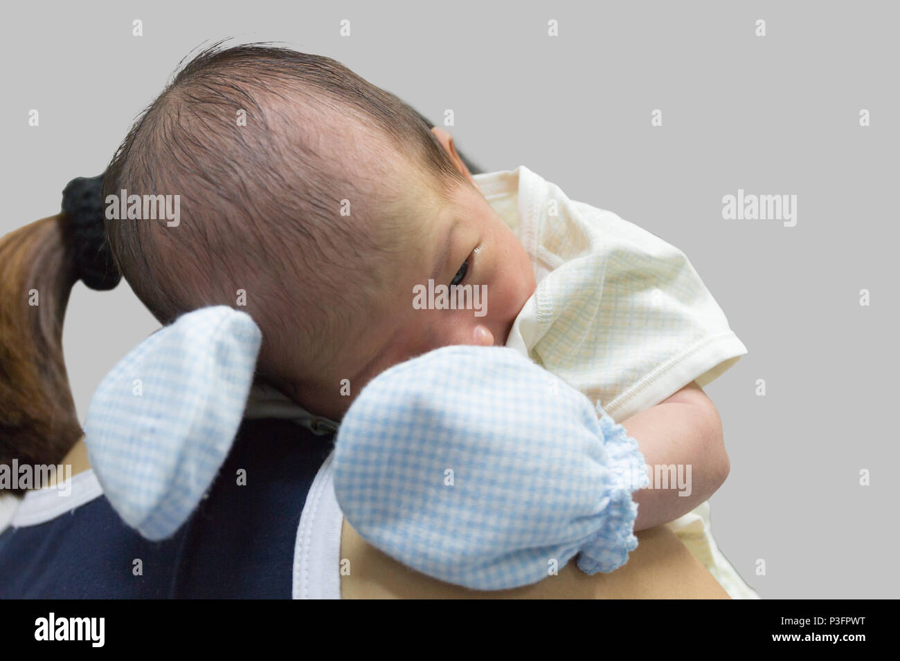 Asian cute new born baby on shoulder mom after crying. Stock Photo