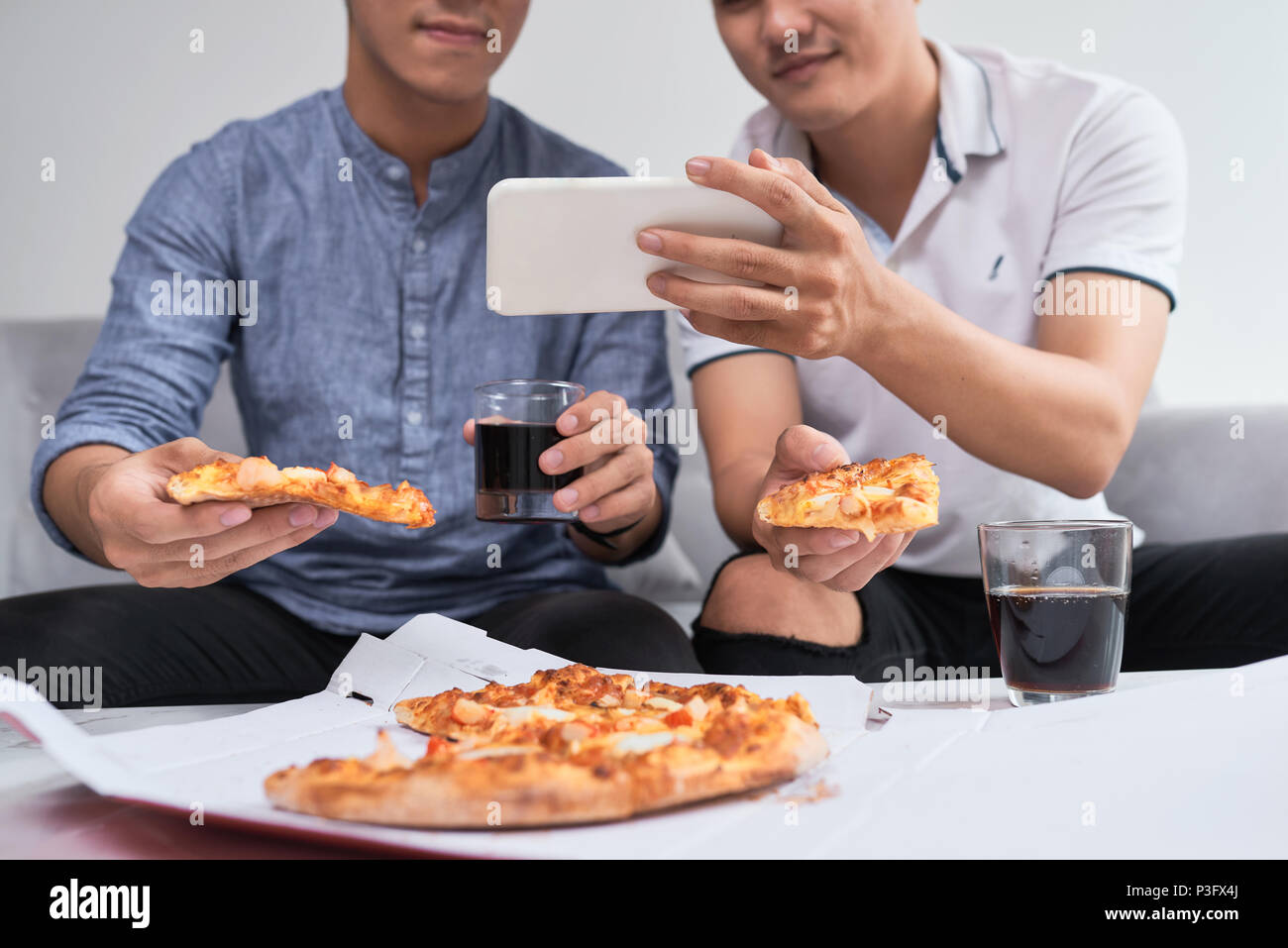 Young friends eating pizza at home on winter reunion - Friendship concept  with happy people enjoying time together and having fun drinking brew pints  Stock Photo - Alamy