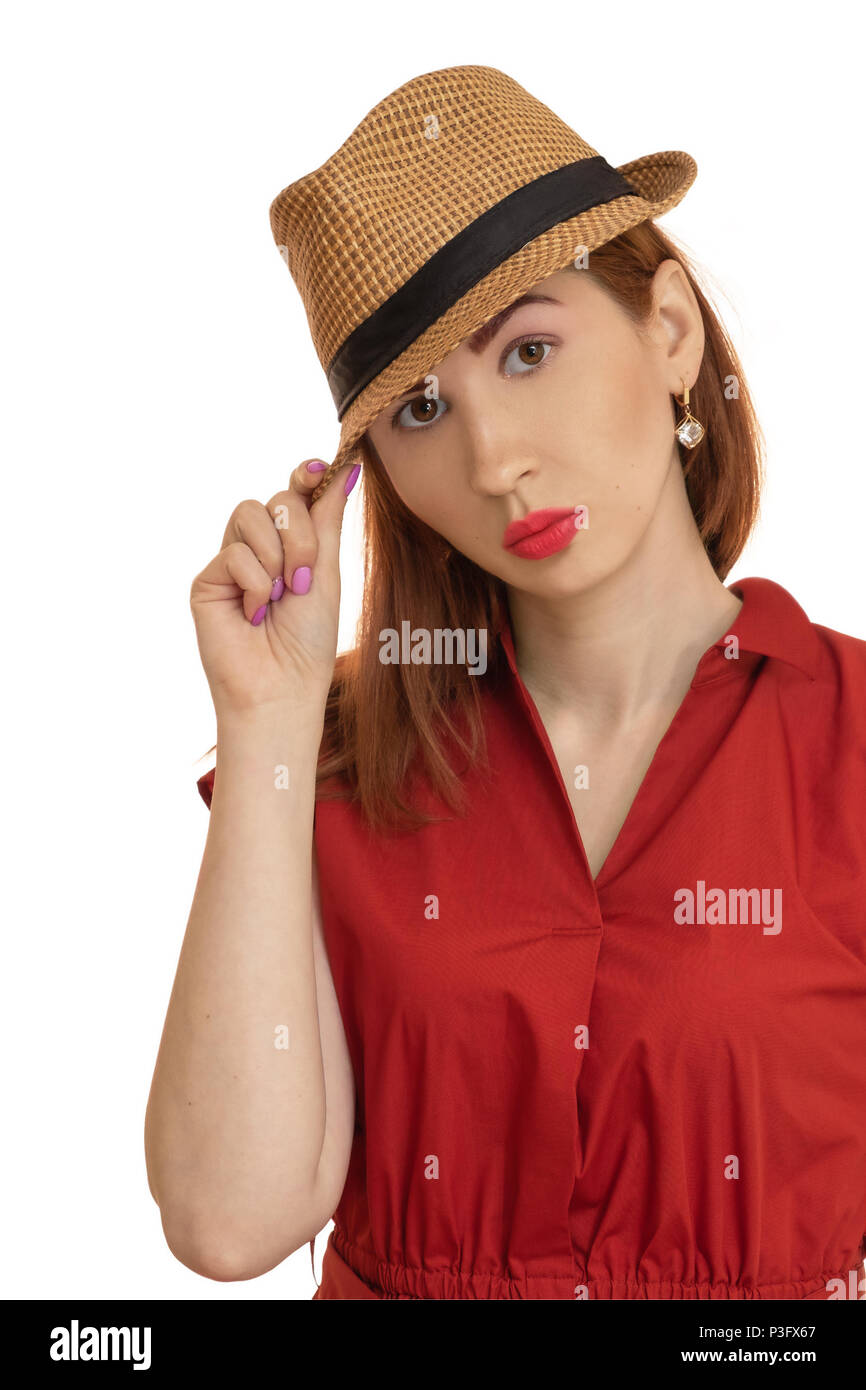 Portrait of the posing girl in a hat and a red dress Stock Photo - Alamy
