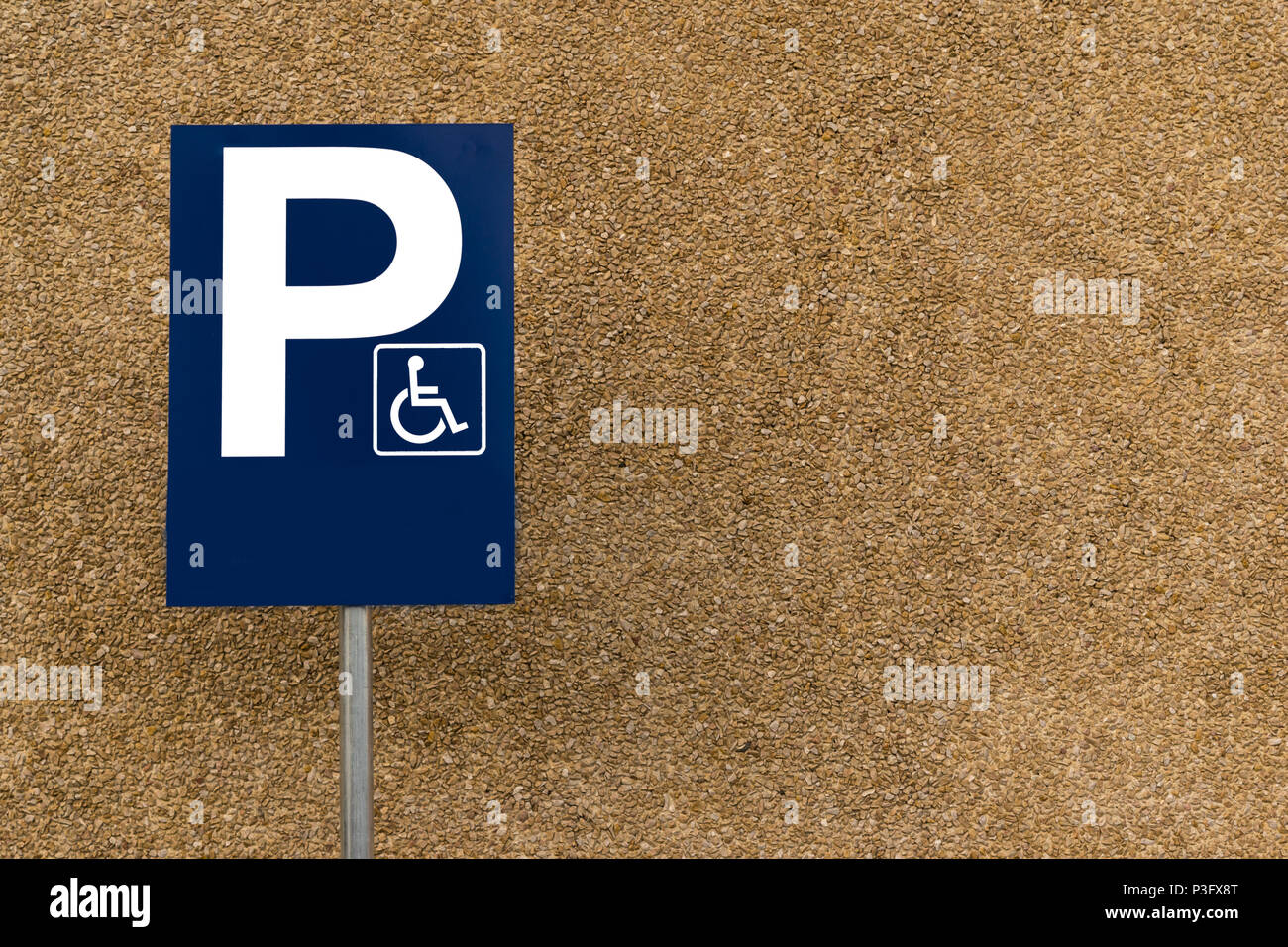 blank handicapped parking street sign on post with rocky background and lots of copy space Stock Photo