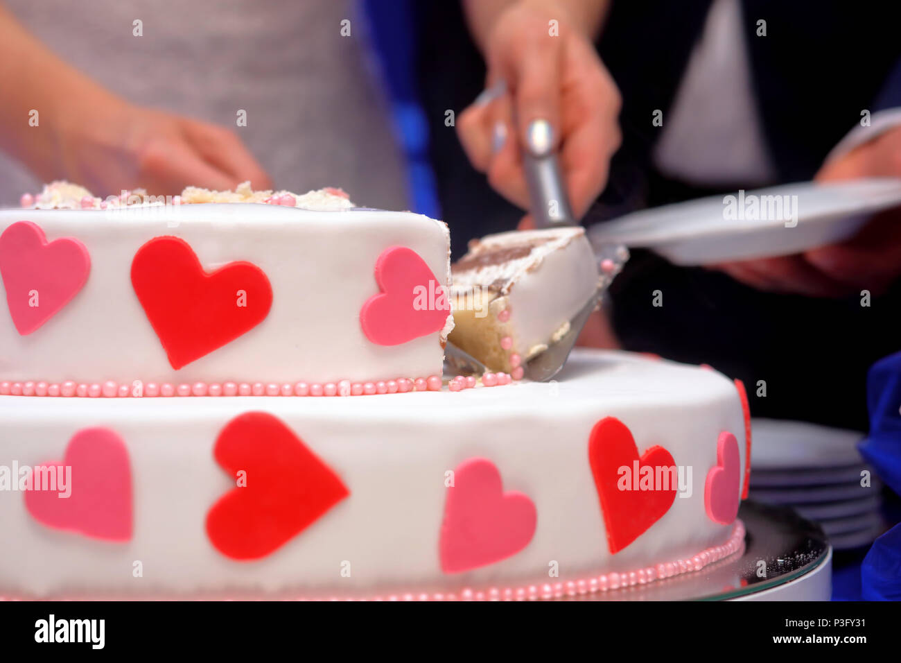 White wedding cake with red hearts on wedding party Stock Photo
