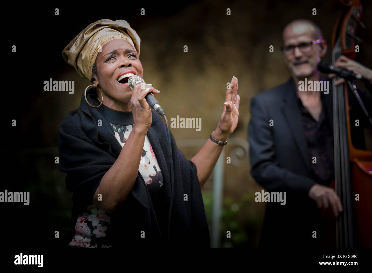 Ley Adewole lead vocalist of The Grace Notes performing at Trebah Garden amphitheatre in Cornwall. Stock Photo